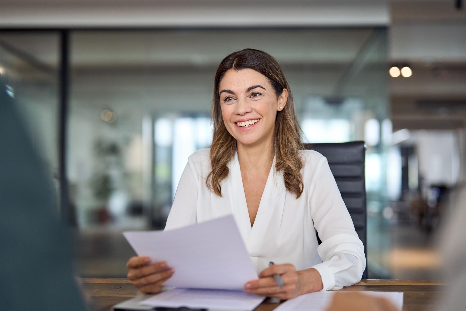 Happy business woman hr manager holding cv at job interview office meeting.